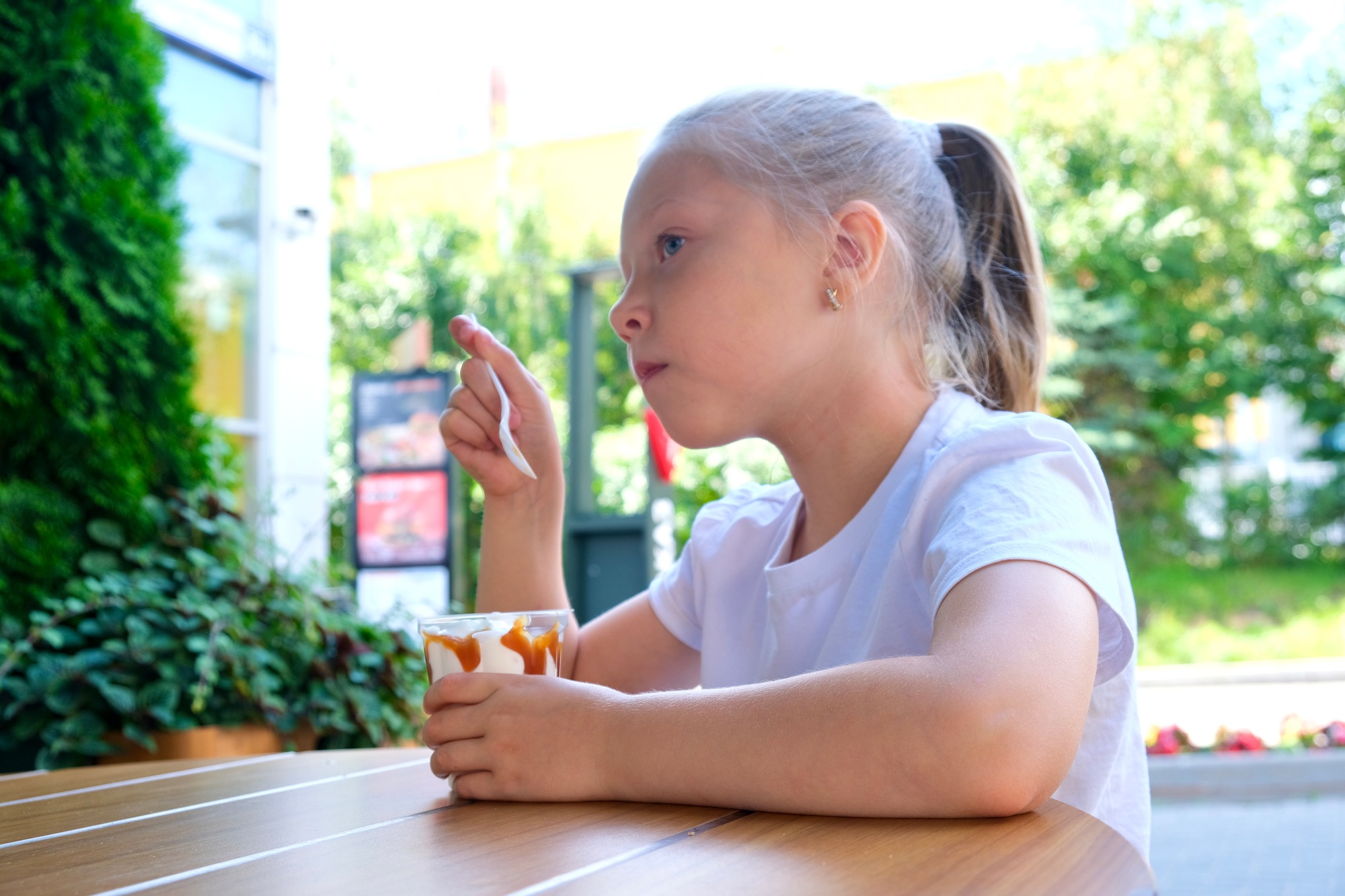 Child eating ice cream on the street