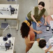 Group of contemporary seamstresses discussing new fashion collection