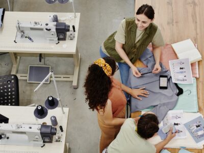 Group of contemporary seamstresses discussing new fashion collection