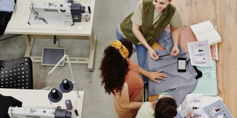 Group of contemporary seamstresses discussing new fashion collection