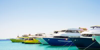 Seascape with parking and anchored boats and ships