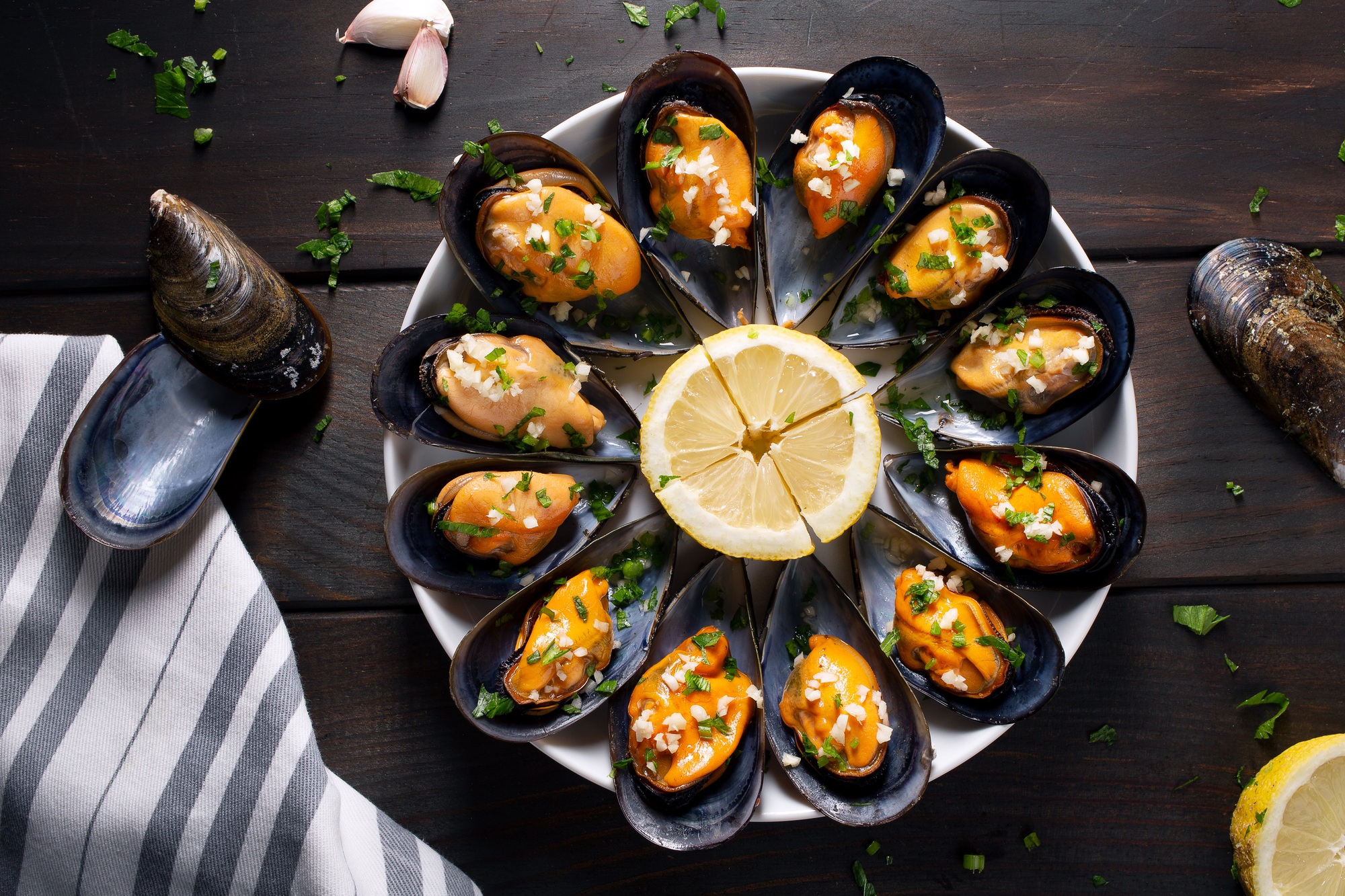 Steamed mussels with parsley and garlic on plate